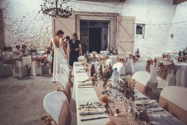 Bride adjusting dress before dinner