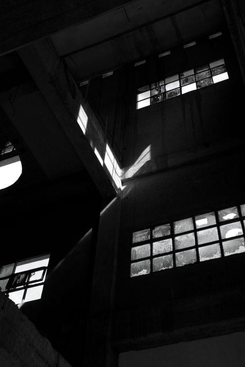 Light getting through broken windows in a leftout factory