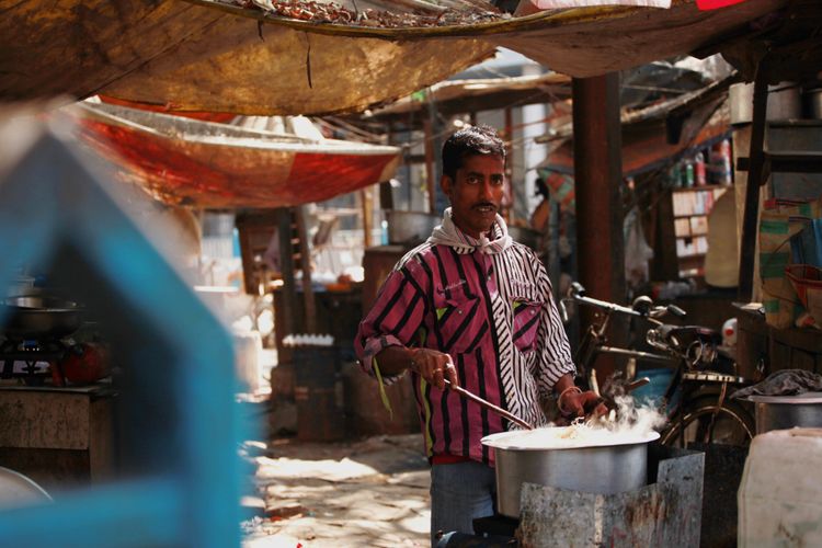 Portrait of a man preparing food in the market of Kolkata